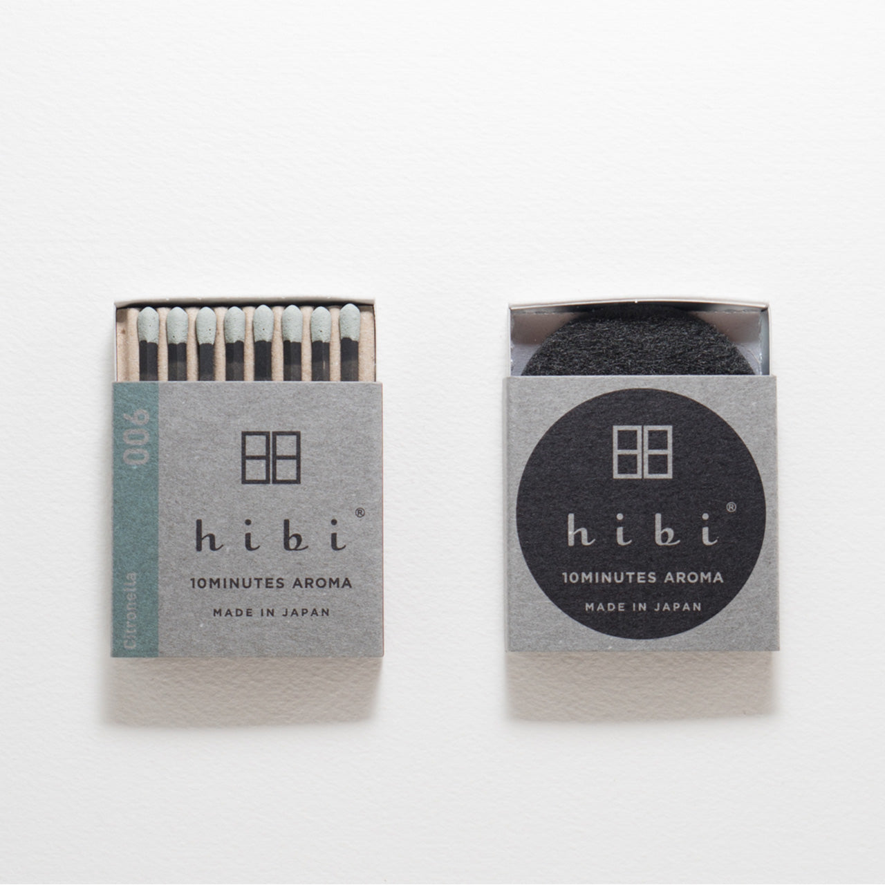 An opened box of Hibi 10 Minutes Aroma Citronella incense matches containing 8 incense sticks with light green tips. Next to it is a box containing a non-flammable incense mat. All set in a white background.