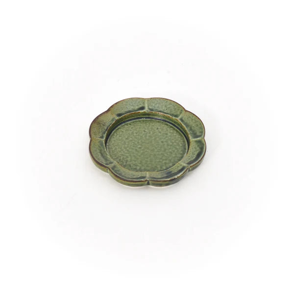 A green flower-shape porcelain Seto incense tray with a white background.