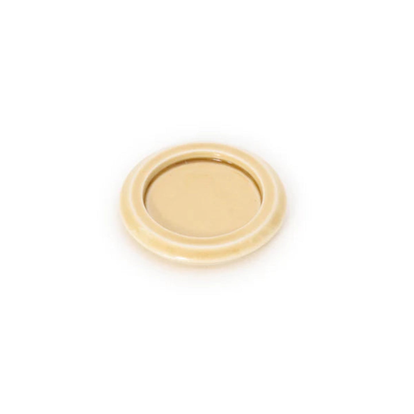 A round yellow porcelain Seto incense tray with a white background.