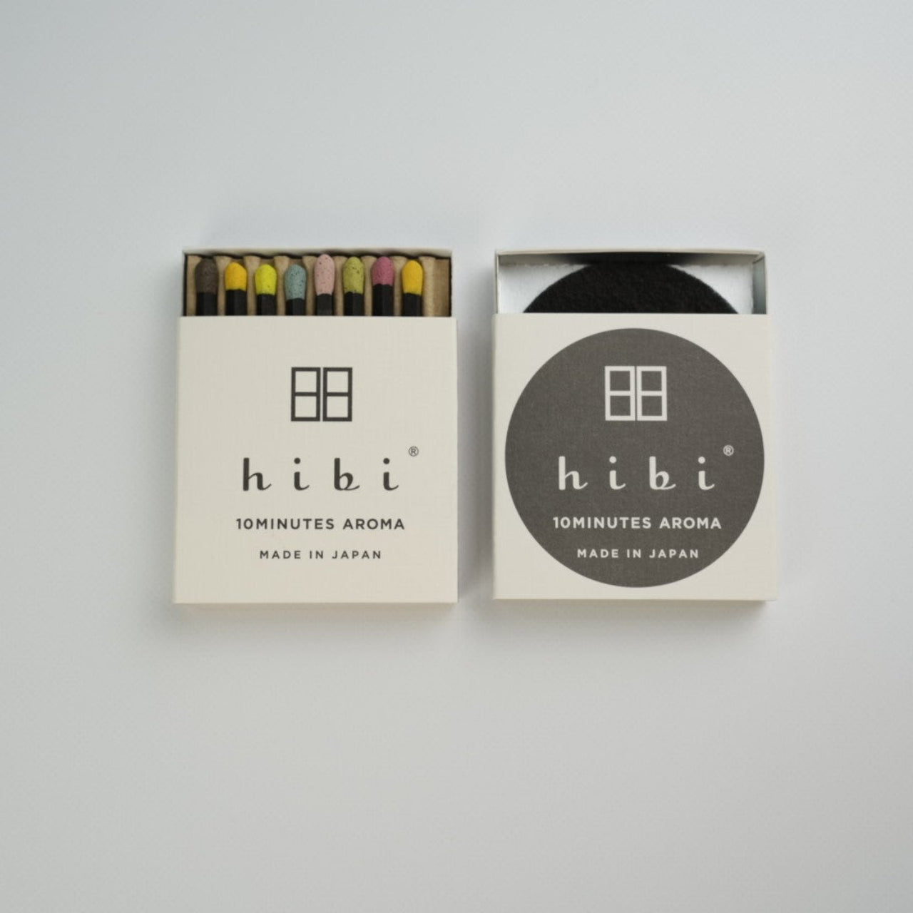 An half opened box of Hibi 10 Minutes Aroma Special Edition showing 8 coloured incense match. Next to it is a box containing a non-flammable incense mat. All set in a white background.