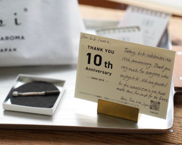 A standing postcard printed "Thank you, 10th Anniversary, since 2015", and the message: Dear hibi lovers, Today, bibi celebrates its 10th  anniversary. Thank you very mch for everyonw who enjoys hibi.