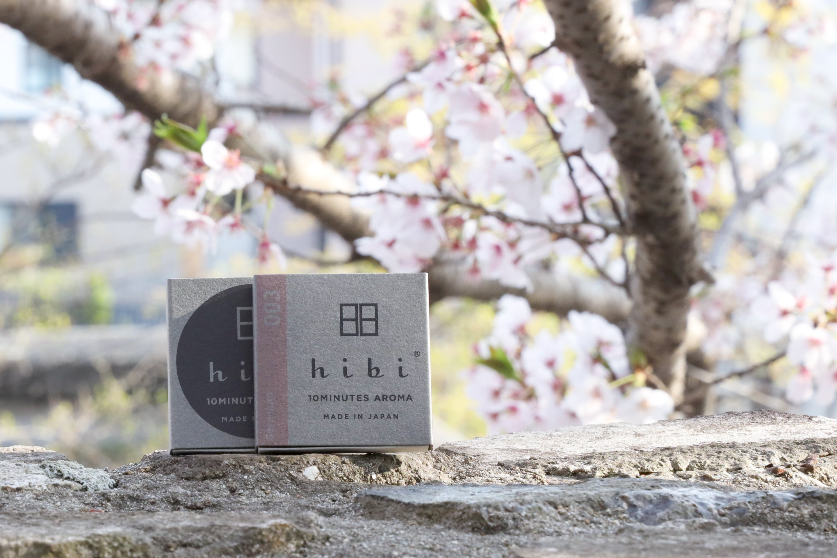 Box of hibi Geranium incense with cherry blossoms in the background